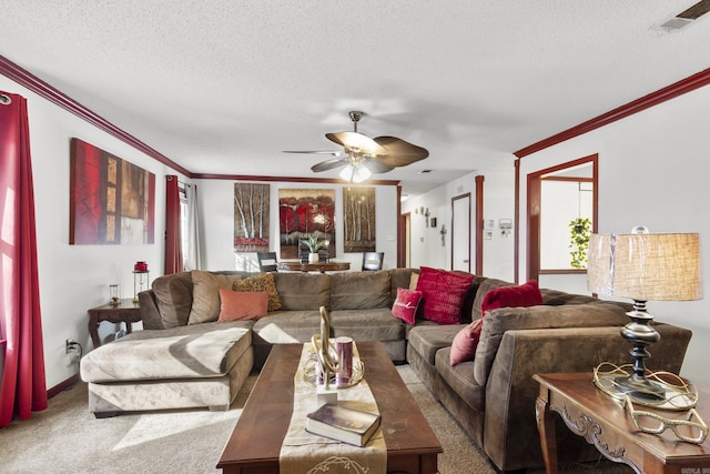 living room with ceiling fan, carpet, a healthy amount of sunlight, a textured ceiling, and ornamental molding