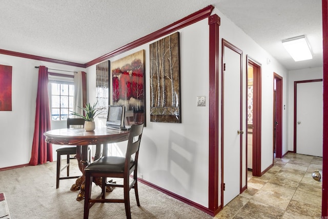 carpeted dining area featuring a textured ceiling