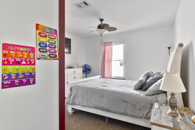 bedroom featuring ceiling fan, carpet, and a textured ceiling