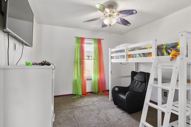 carpeted bedroom featuring ceiling fan and a textured ceiling