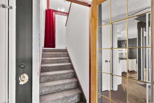 stairway with a textured ceiling