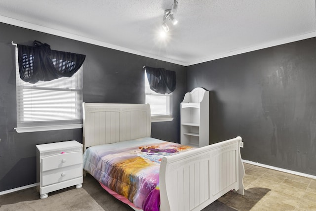 bedroom featuring a textured ceiling, ornamental molding, and rail lighting