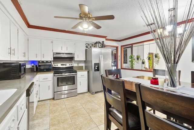 kitchen featuring light tile patterned flooring, appliances with stainless steel finishes, ornamental molding, and white cabinets