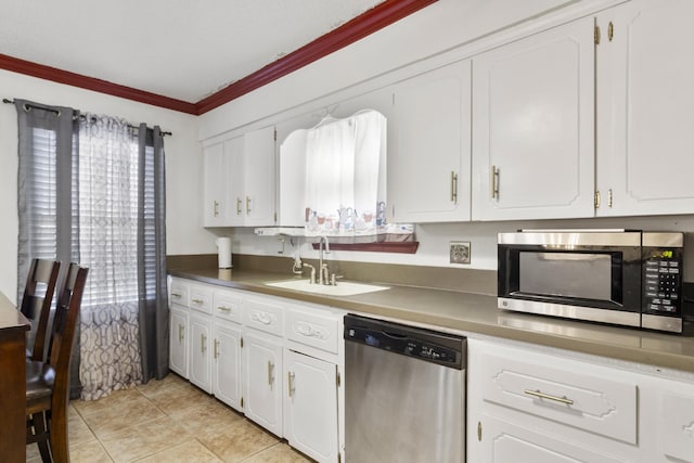 kitchen with sink, crown molding, white cabinets, and stainless steel appliances