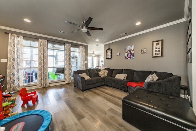 living room with hardwood / wood-style flooring, plenty of natural light, ornamental molding, and ceiling fan