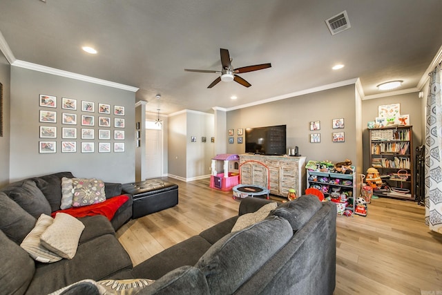 living room with ceiling fan, ornamental molding, and light hardwood / wood-style flooring