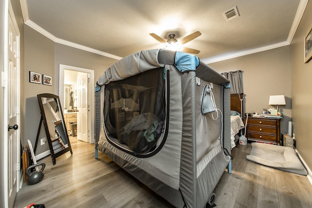 bedroom with ceiling fan, crown molding, connected bathroom, and hardwood / wood-style flooring