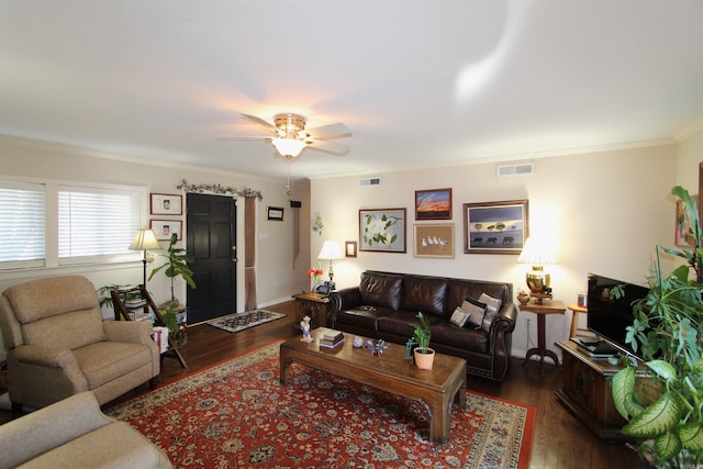 living room featuring ceiling fan, ornamental molding, and dark hardwood / wood-style floors