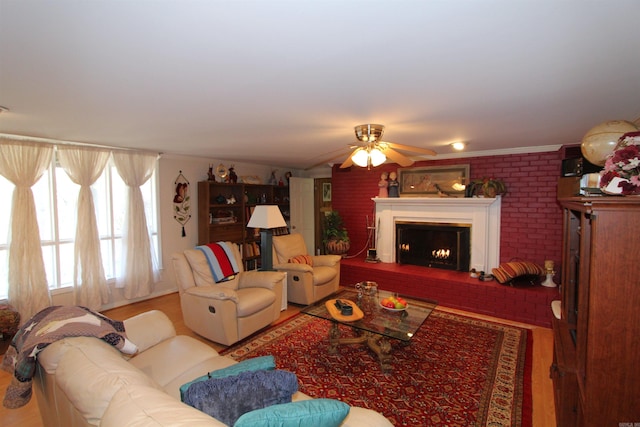 living room with ceiling fan and crown molding