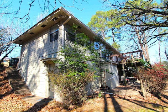 view of side of property featuring a wooden deck