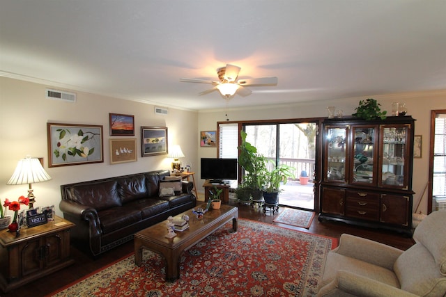 living room with hardwood / wood-style flooring, ornamental molding, and ceiling fan