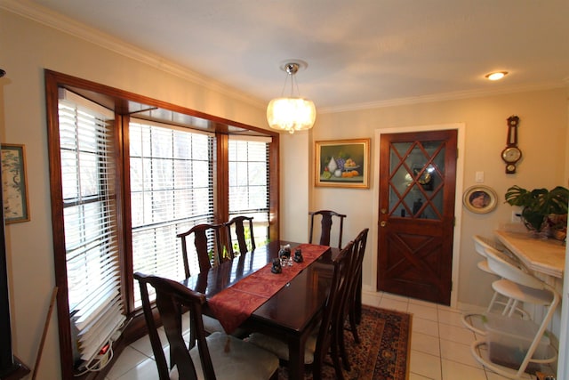 dining room with light tile patterned floors and crown molding