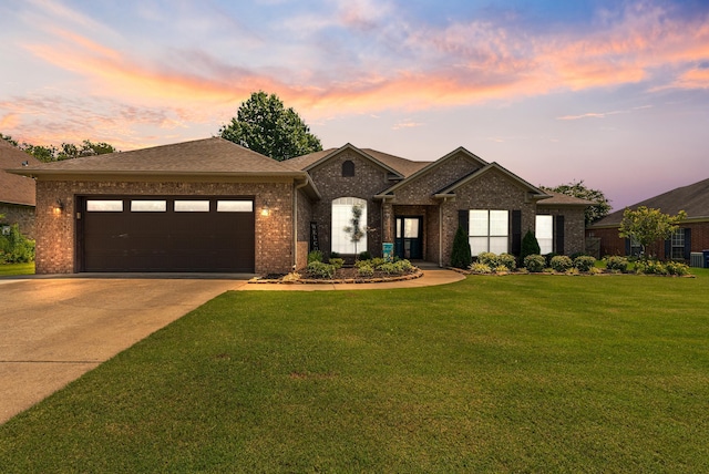 view of front of property featuring a garage and a lawn