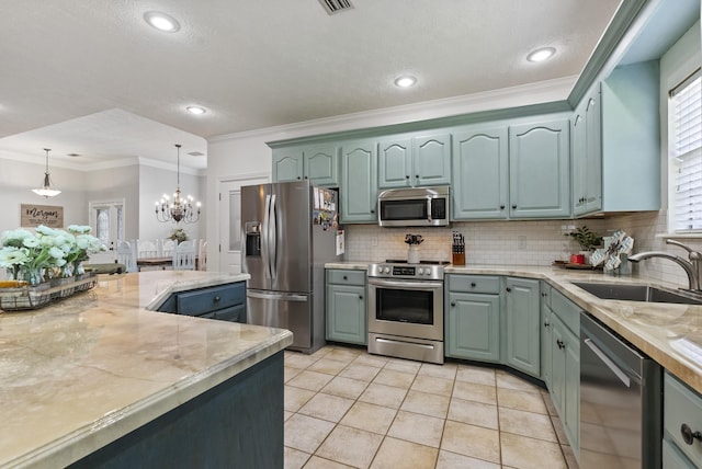 kitchen with pendant lighting, stainless steel appliances, tasteful backsplash, sink, and light tile patterned floors