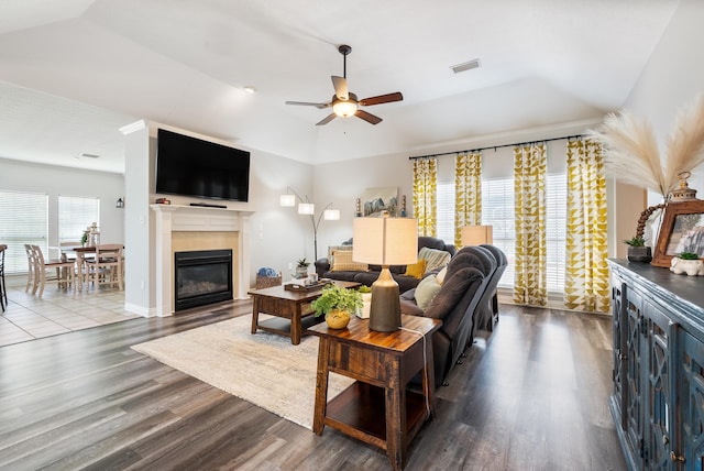 living room featuring light hardwood / wood-style floors, a raised ceiling, and ceiling fan