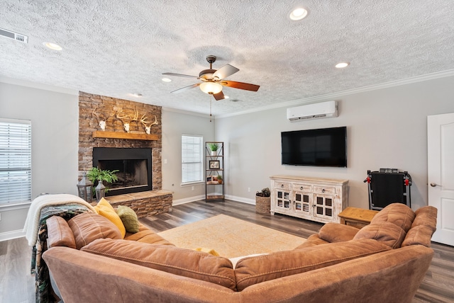 living room featuring a textured ceiling, dark hardwood / wood-style floors, ornamental molding, and a wall mounted air conditioner