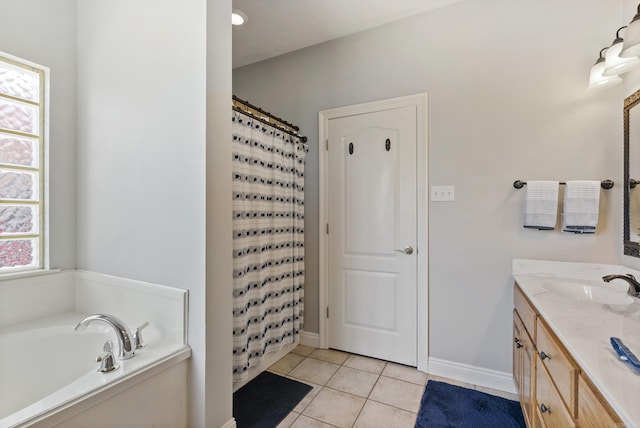 bathroom with plus walk in shower, vanity, and tile patterned flooring