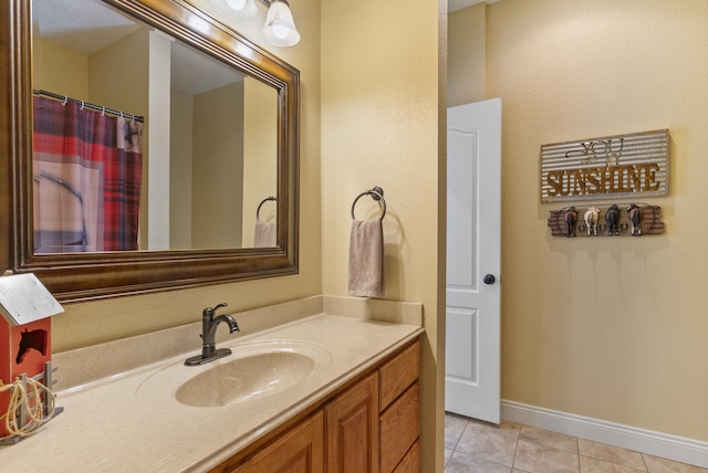 bathroom featuring tile patterned flooring and vanity