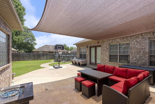 view of patio / terrace featuring an outdoor living space with a fire pit and area for grilling