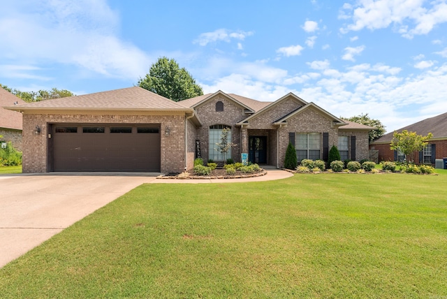 view of front of home with a front lawn and a garage