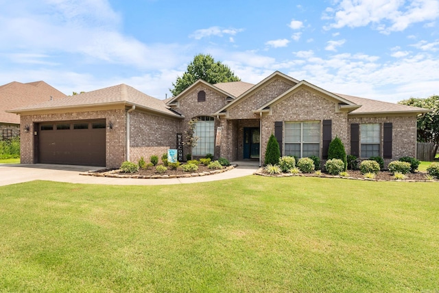 view of front of property with a garage and a front lawn