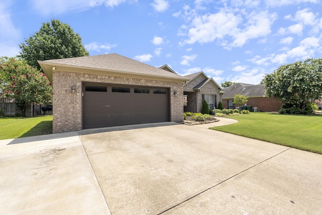 view of front of house with a front yard and a garage