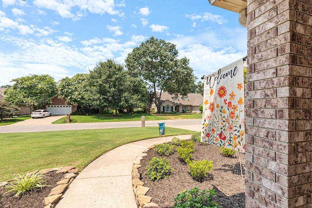 view of home's community with a yard