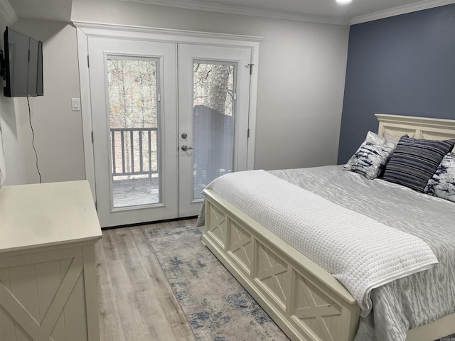 bedroom with light wood-type flooring, access to exterior, crown molding, and french doors