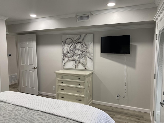 bedroom featuring dark wood-type flooring and ornamental molding