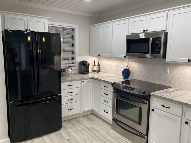 kitchen with light stone counters, white cabinets, and stainless steel appliances