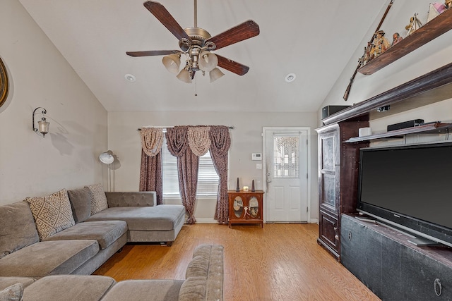 living room with vaulted ceiling, ceiling fan, and light hardwood / wood-style flooring