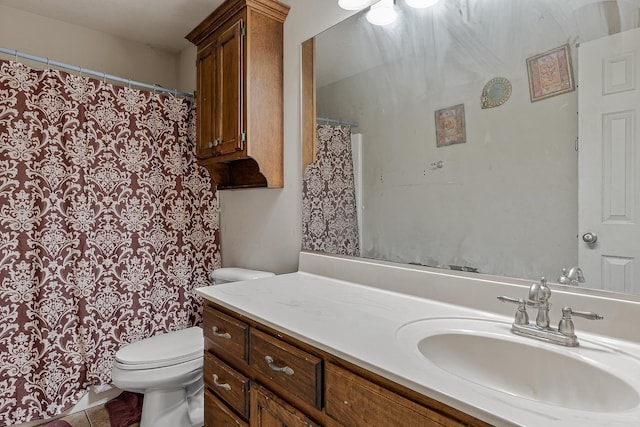 bathroom with toilet, vanity, and tile patterned floors