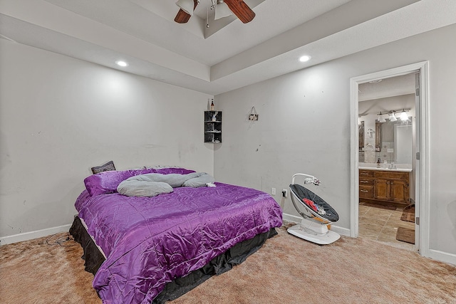 carpeted bedroom with ceiling fan, sink, and ensuite bathroom