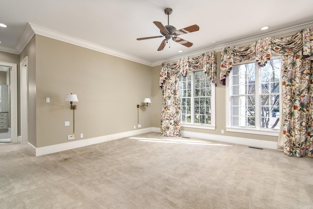 carpeted empty room with ceiling fan and ornamental molding