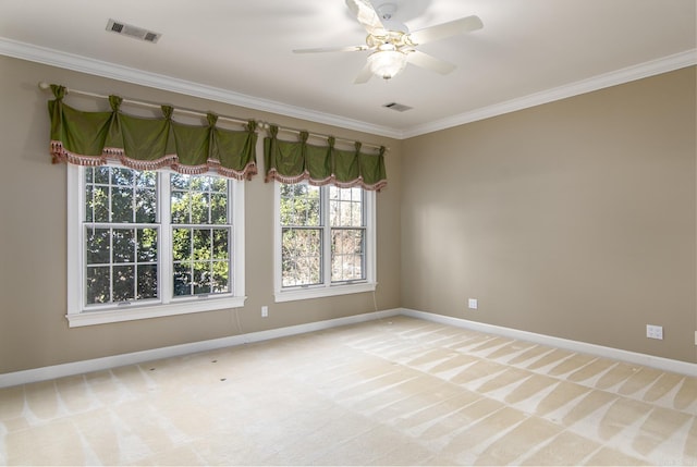 carpeted spare room featuring ceiling fan and ornamental molding