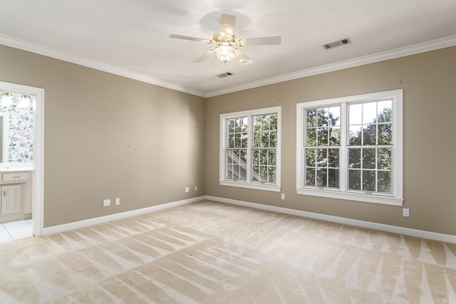 carpeted spare room featuring ceiling fan and ornamental molding