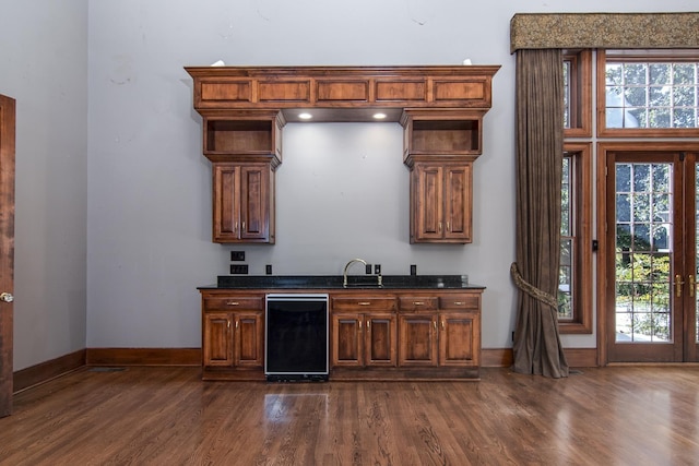 bar featuring dark wood-type flooring and sink