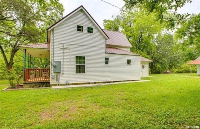 rear view of property with a yard