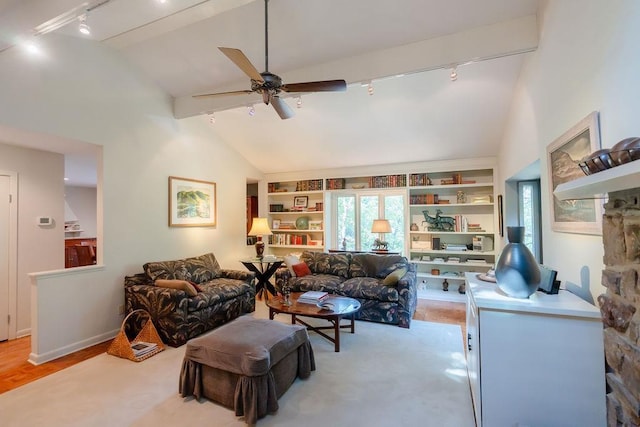 living room with rail lighting, ceiling fan, lofted ceiling, light hardwood / wood-style flooring, and built in shelves