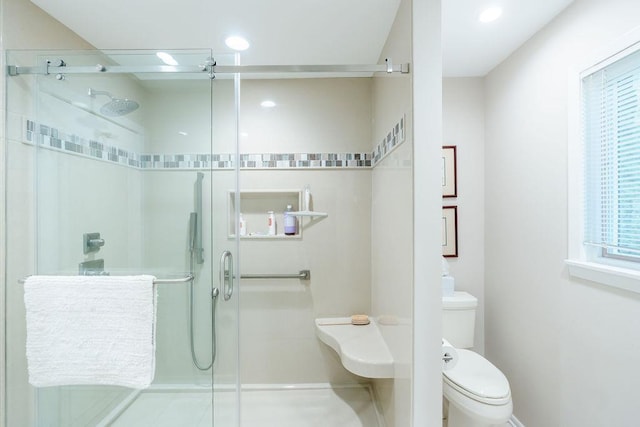 bathroom with toilet and walk in shower