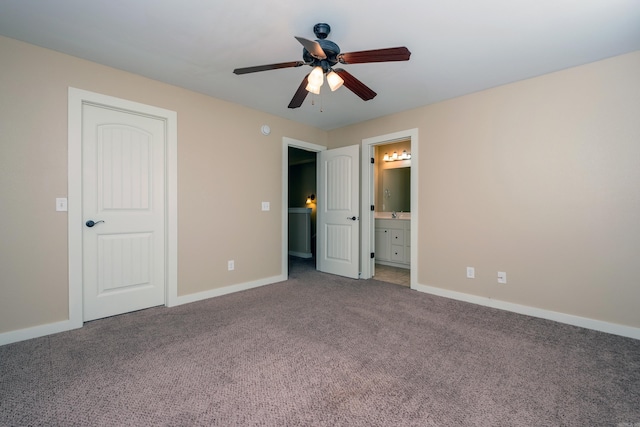 unfurnished bedroom with ceiling fan, ensuite bathroom, and carpet flooring