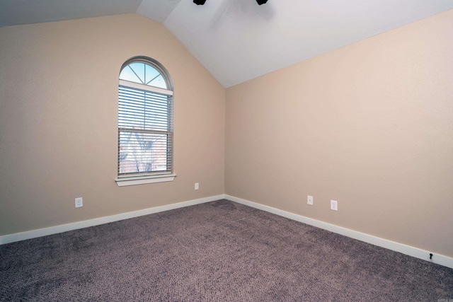 carpeted empty room with lofted ceiling