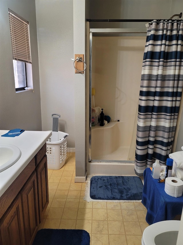 bathroom with vanity, tile patterned flooring, and walk in shower