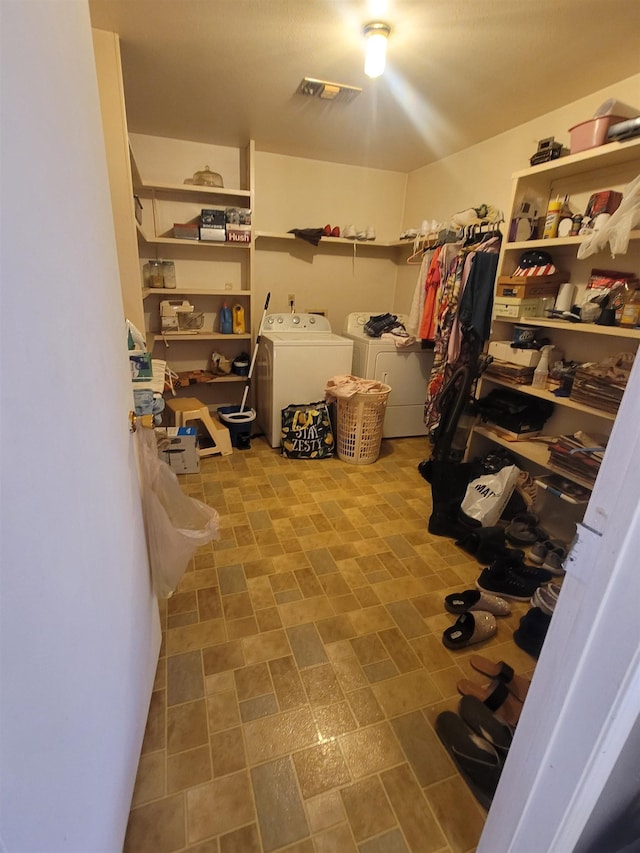 walk in closet featuring washing machine and dryer