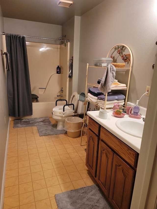 full bathroom featuring shower / bath combo with shower curtain, tile patterned floors, vanity, and toilet