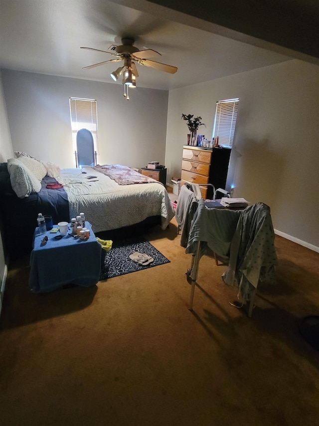 bedroom featuring ceiling fan and carpet