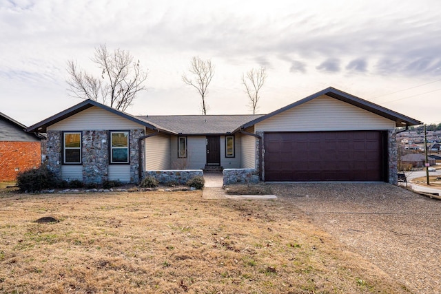 ranch-style house with a garage and a front yard