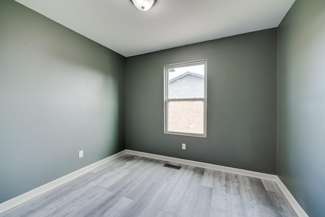 spare room with light hardwood / wood-style floors