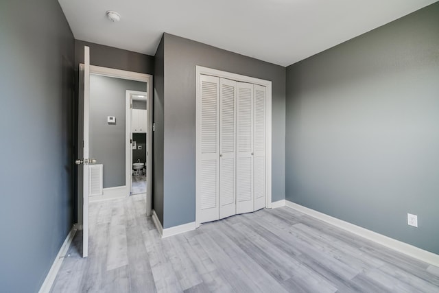 unfurnished bedroom featuring light hardwood / wood-style floors and a closet