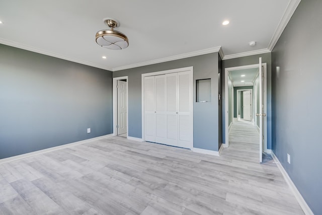 unfurnished bedroom with light wood-type flooring, a closet, and ornamental molding